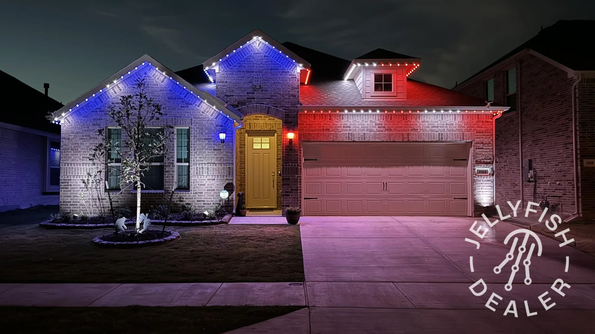 Home roofline illuminated in red and blue permanent outdoor lighting