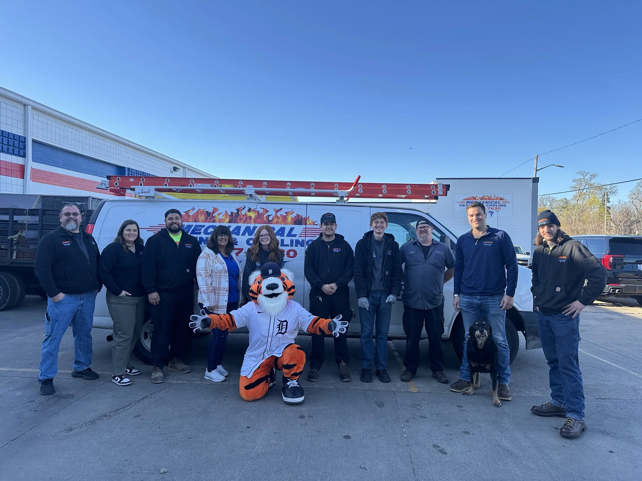 Mechanical Heating, Cooling & Electrical team with mascot, service van, and company dog