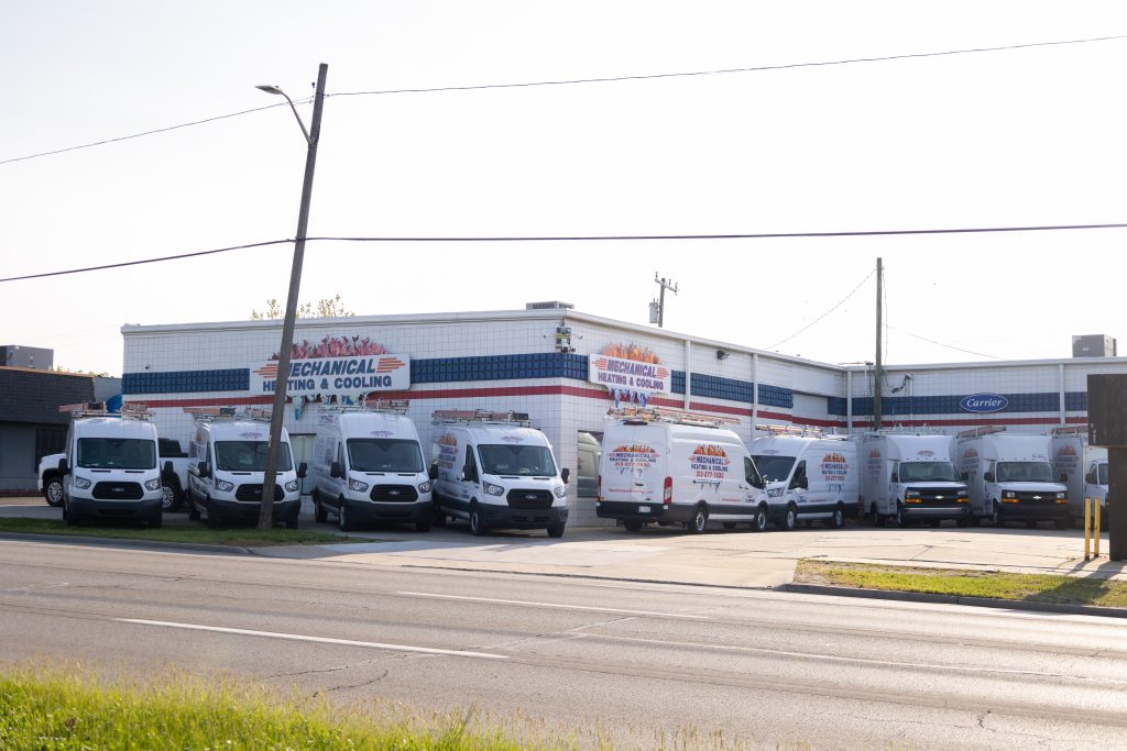 Mechanical Heating & Cooling service vehicles parked outside their facility in Dearborn Heights, showcasing the company's commitment to HVAC services and customer comfort.